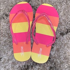 Pink, orange, and yellow rubber flip flops